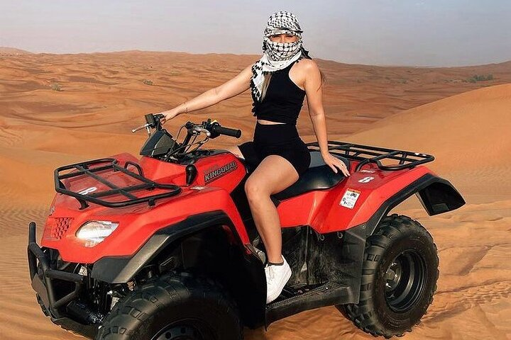 Experience the vast beauty of the desert as you navigate the sandy dunes on a quad bike surrounded by stunning landscapes and tranquility. Adventure awaits in every ride.